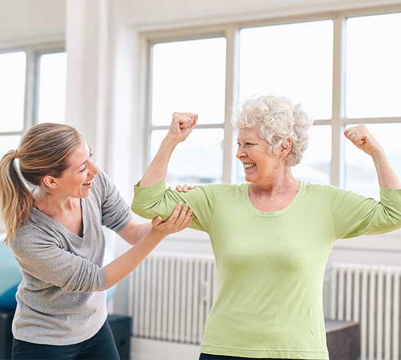 seniors smile while doing physical therapy